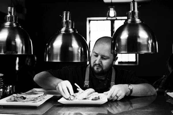 a person sitting at a table with a knife