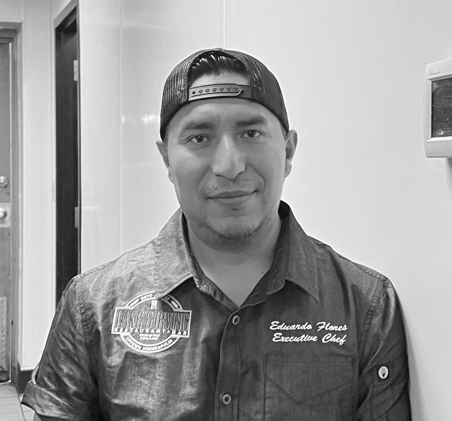 a man wearing a hat and smiling at the camera