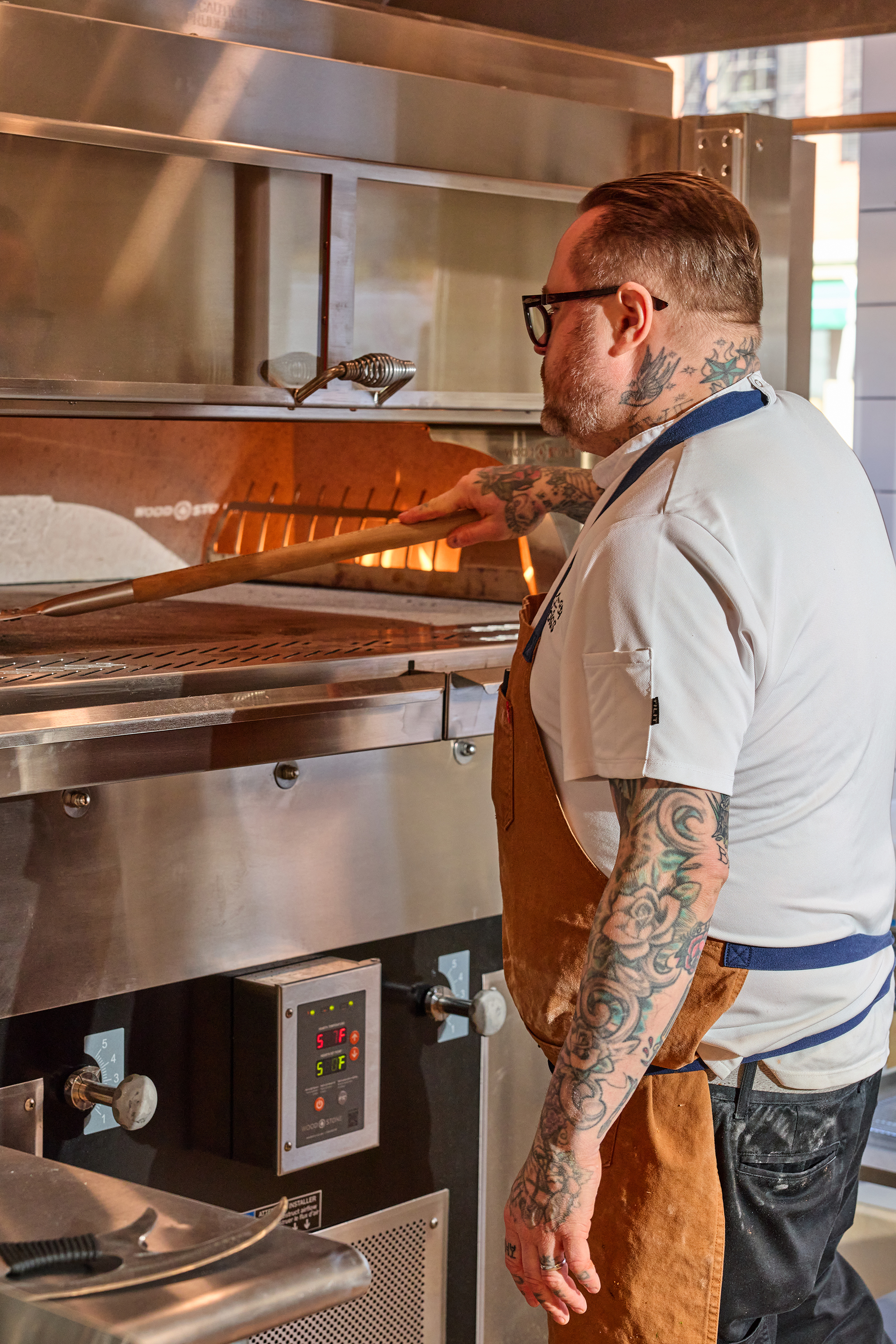 a man in an apron cooking in a kitchen