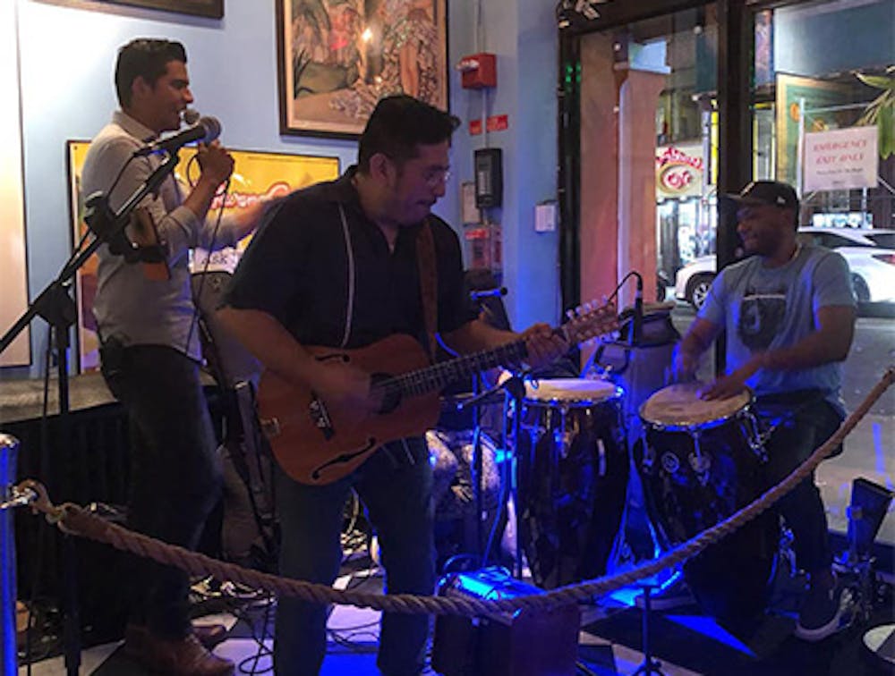 Three musicians performing live Latin music near Lincoln Square, Manhattan NY.