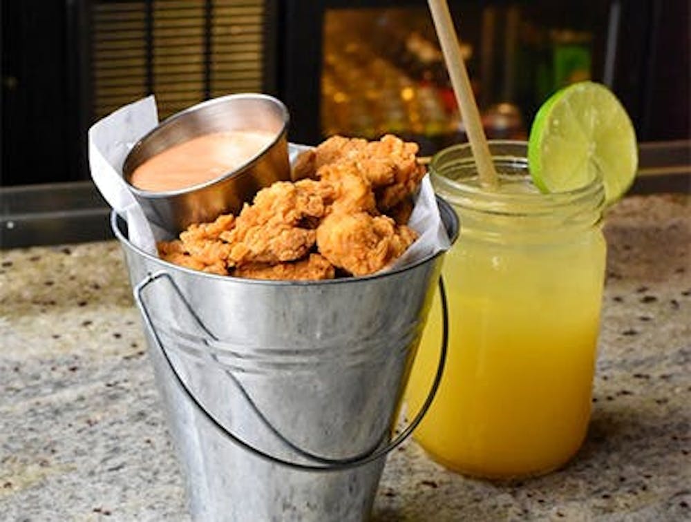 Chicharrones De Pollo, one of our New Cassel Happy Hour food specials, and a cocktail.