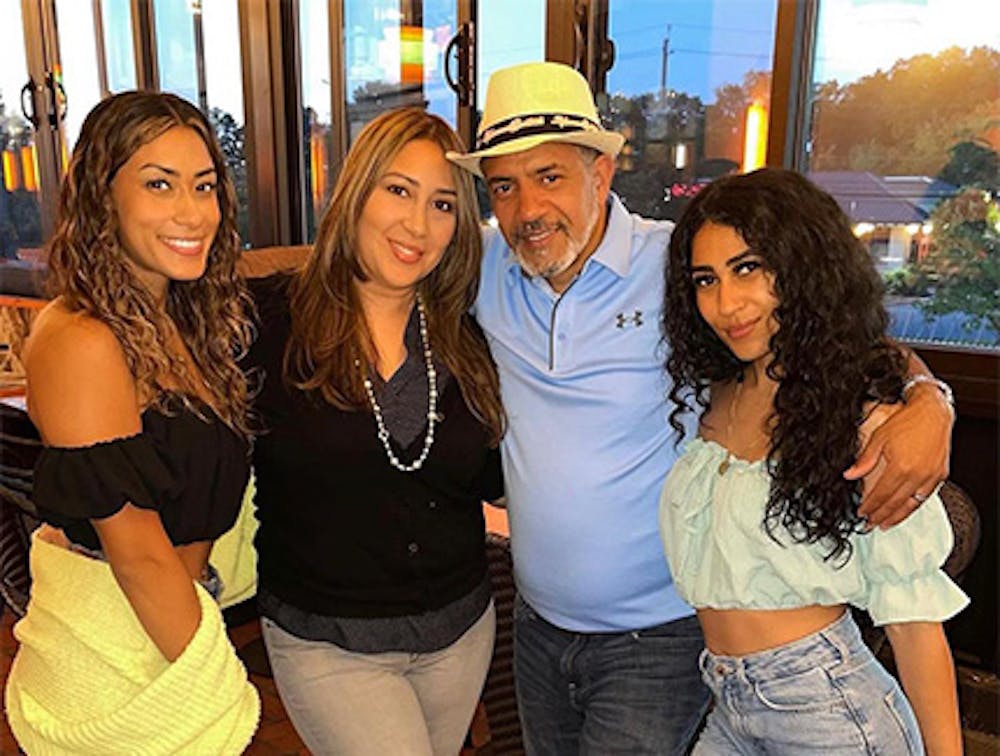 Four happy patrons smiling at our Cuban restaurant near Williston Park, New York.