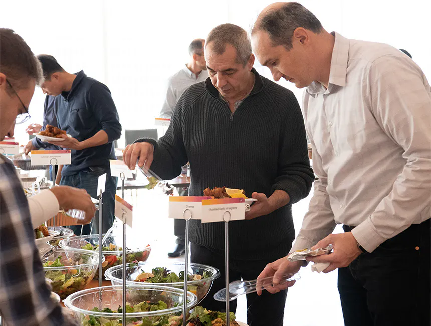 Male employees taking chicken and salads from our office party catering near Hofstra University, NY.