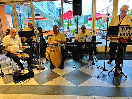Five musicians performing live Latin music near Mott Section, Garden City, NY.
