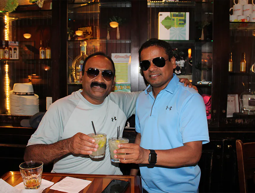 Two male employees enjoying drinks for corporate happy hour near Midtown South, Manhattan, New York.