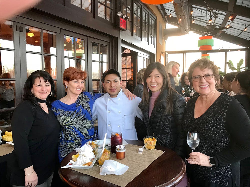 Party guests taking a photo with an employee at our Avenel, Woodbridge Township event space.