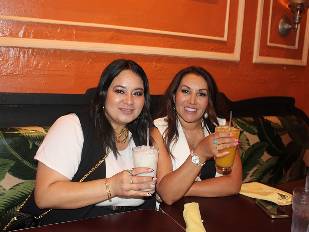 Two women sitting at a booth in our top event venue near Bowery, Manhattan, NYC.