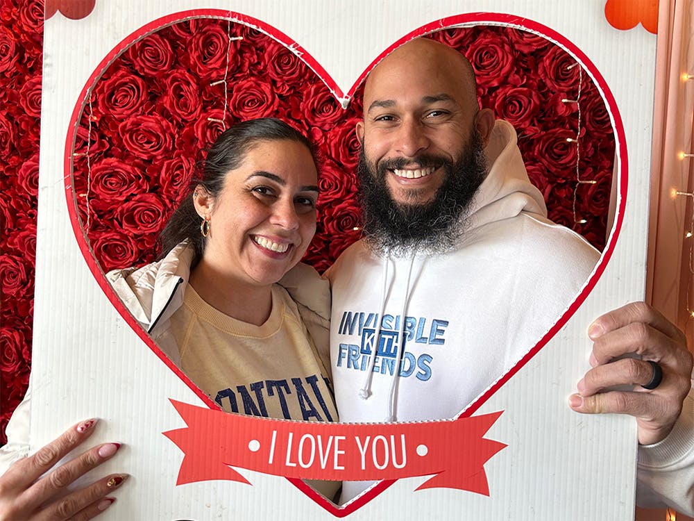 Man and woman taking a photo with a heart-shaped cutout at our event space near Bowery, Manhattan NY.