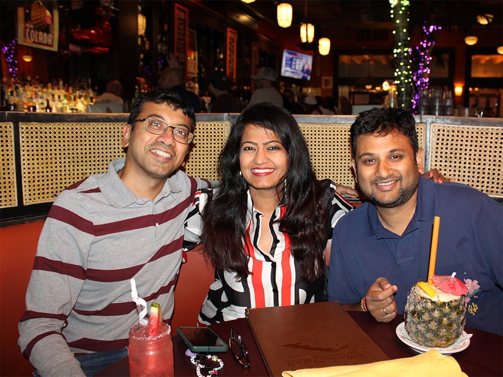 Three people sitting at a table at our Manhattan party venue.