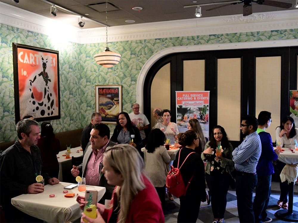People enjoying cocktails and food in the Side Room of our party venue near Williston Park, New York.