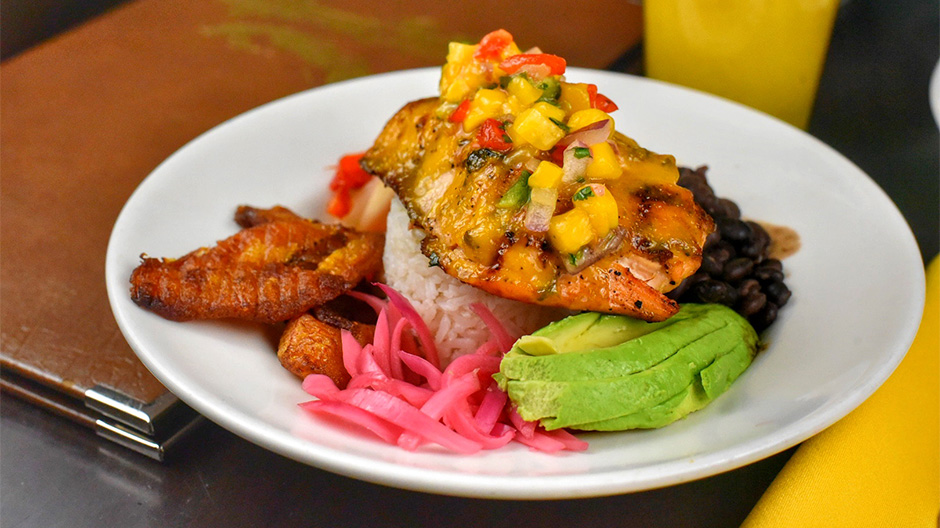 A Hell's Kitchen, Manhattan, NYC Lunch Bowl with salmon, black beans, avocado, rice, and fried plantains.