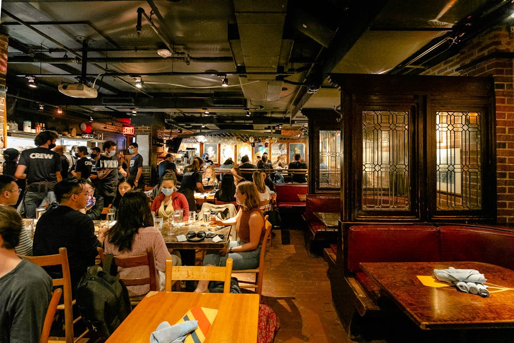 a group of people sitting at a table in a restaurant
