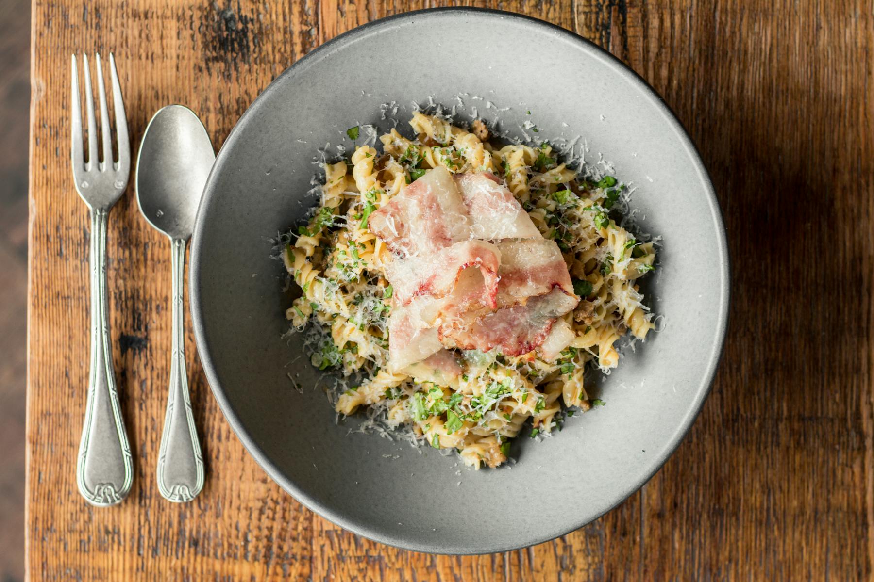 a bowl of food on a wooden table