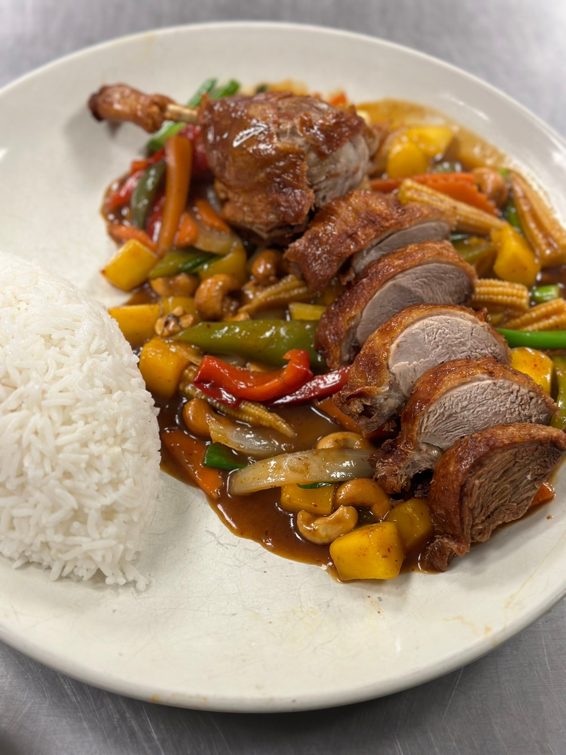 a plate of food with rice meat and vegetables