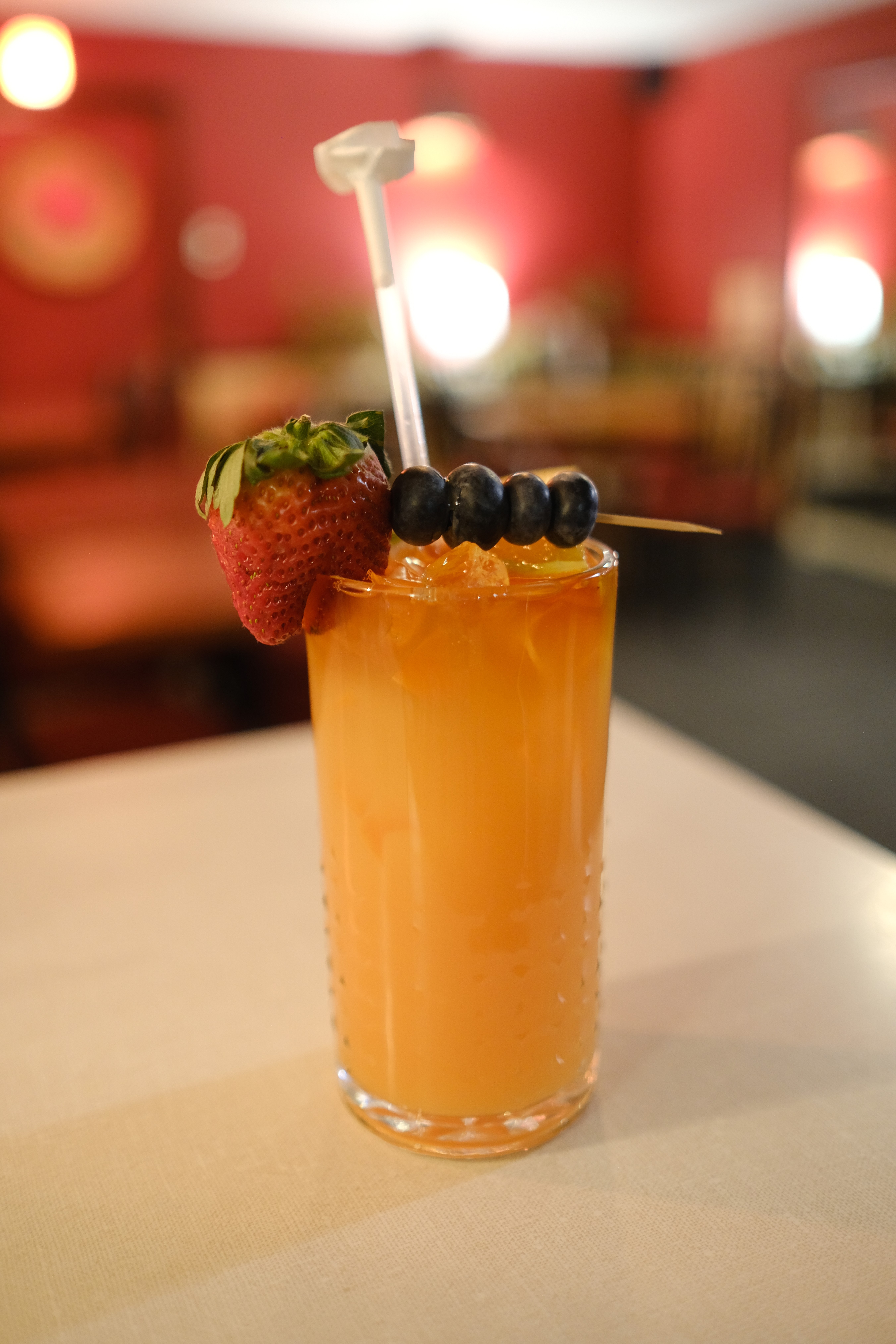 a close up of a glass of orange juice