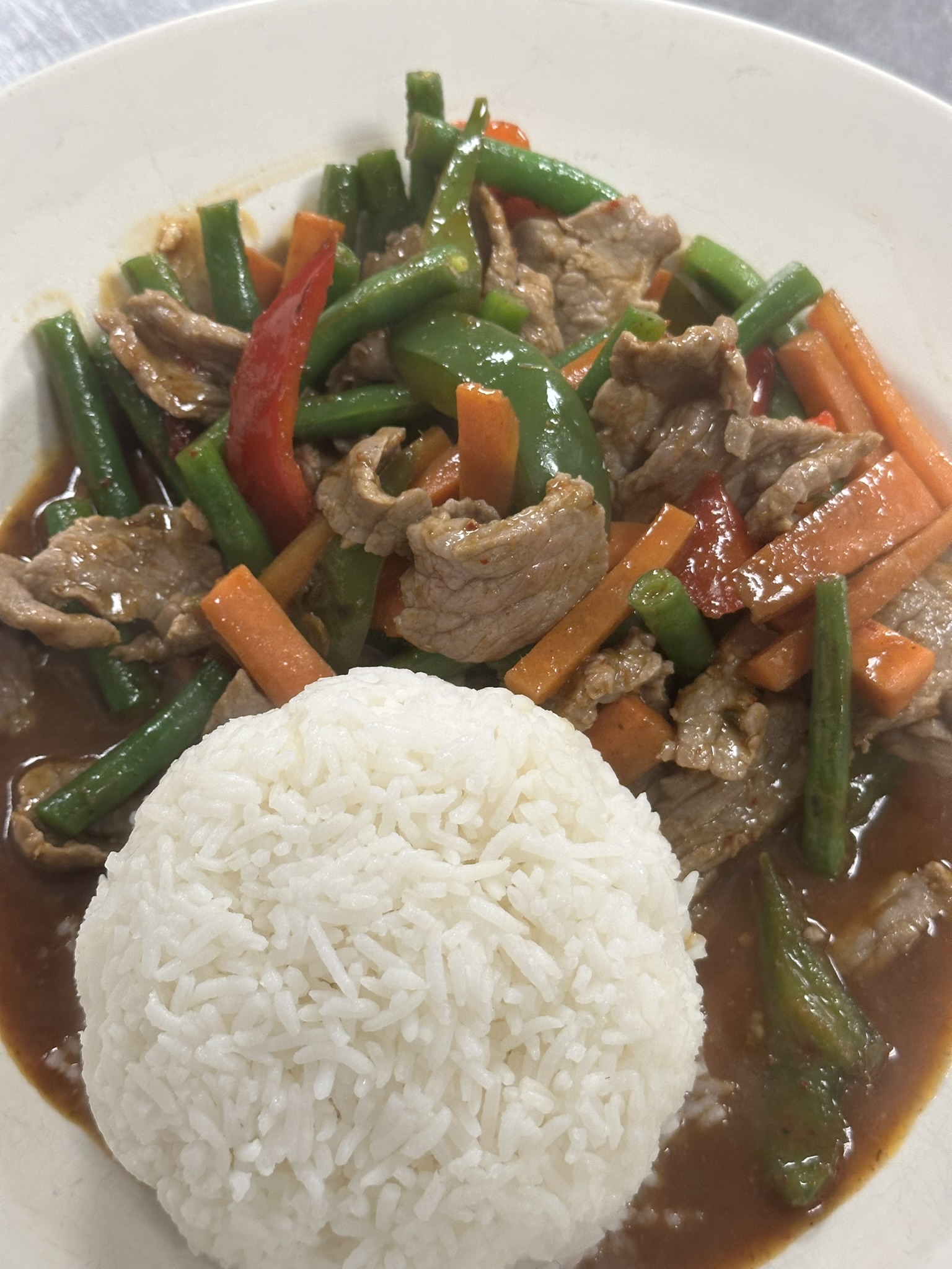 a plate of food with rice meat and vegetables