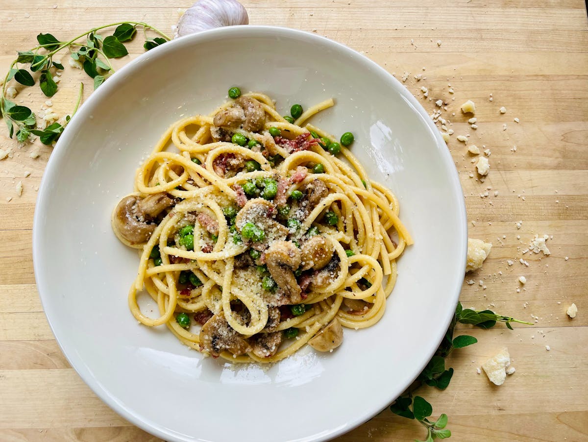 Bucatini with peas, prosciutto, pancetta, mushrooms, garlic and olive oil
