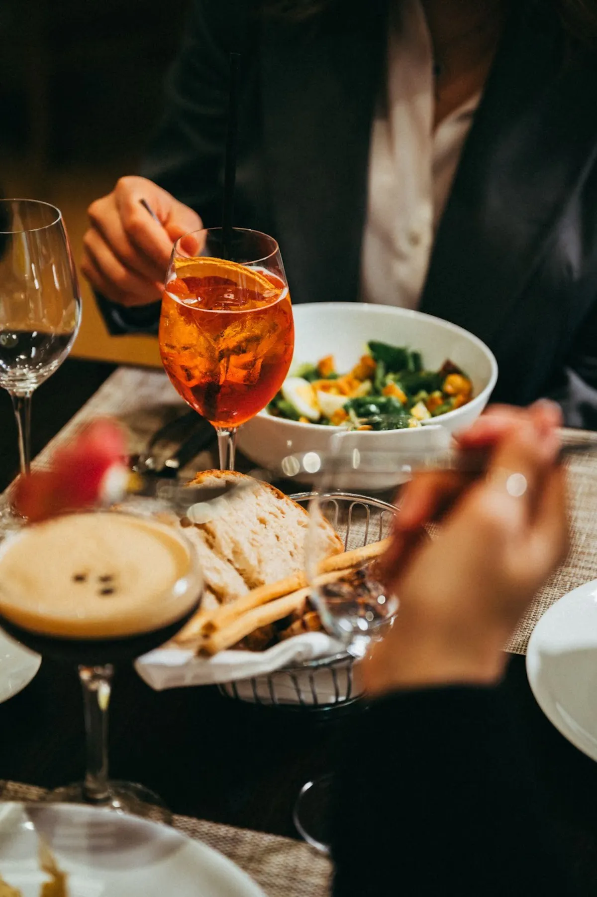 a person sitting at a table with a plate of food