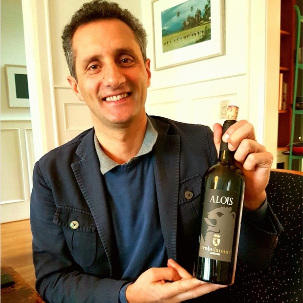 a man holding a bottle of wine