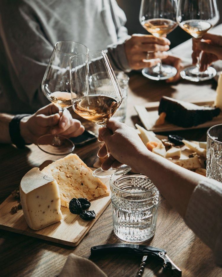 a group of people sitting at a table with a plate of food