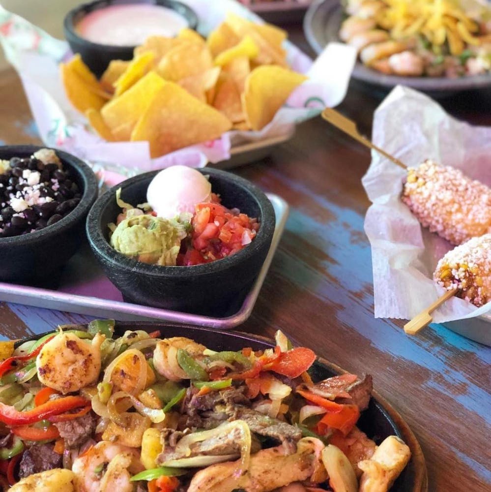 a bunch of food sitting on top of a wooden table