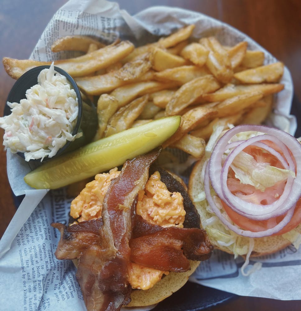 a plate of food with a sandwich and fries on a table