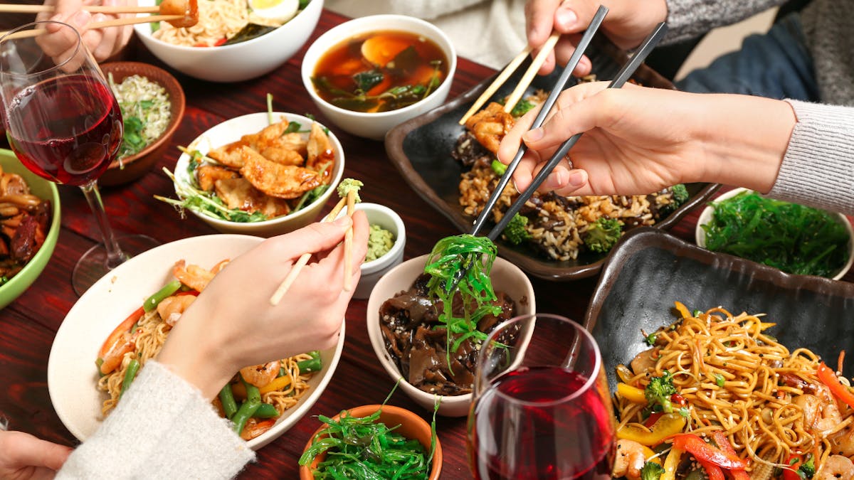 a woman sitting at a table with a plate of food