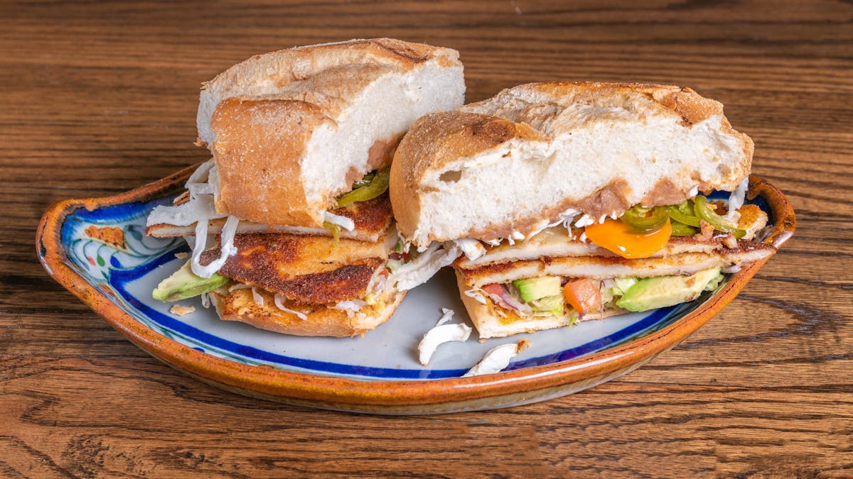 a sandwich cut in half on a plate