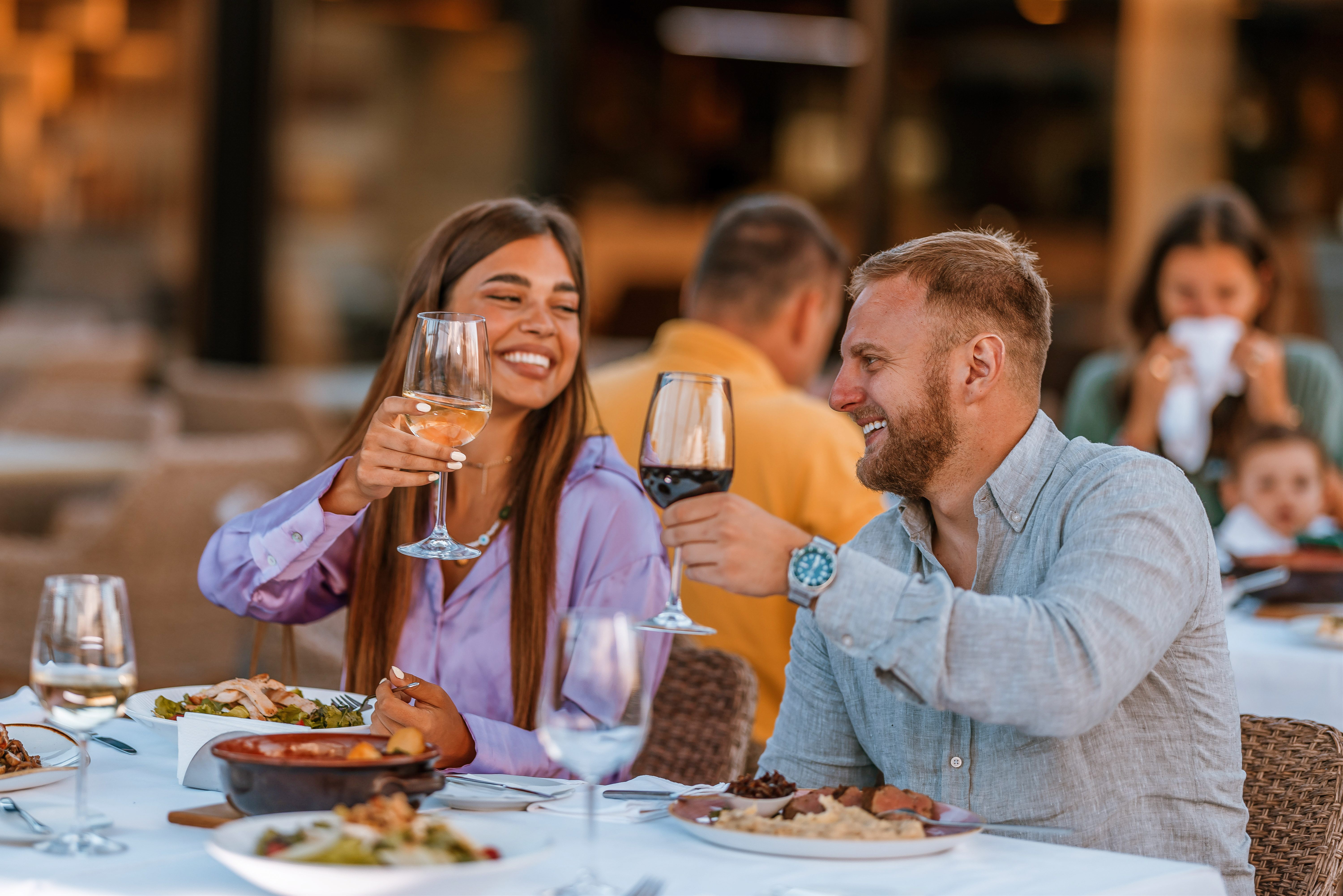 a man and a woman sitting at a table eating food