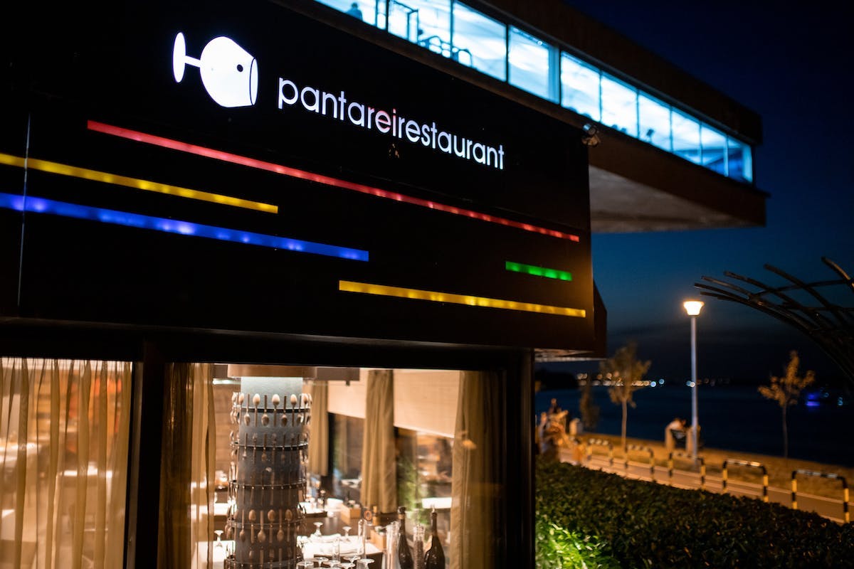 a sign above a store front at night