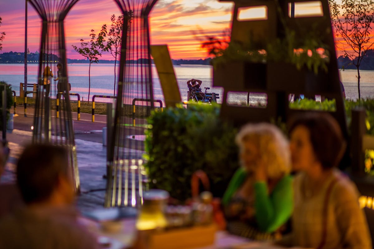 a group of people sitting at a table in a restaurant