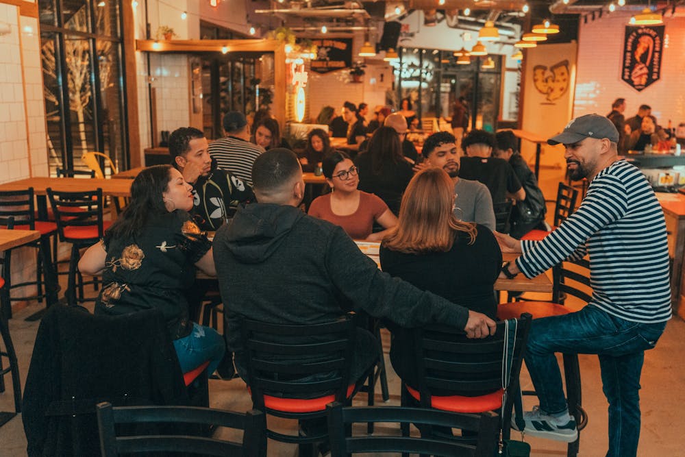 Durga Shakti Nagpal et al. sitting at a table in a restaurant