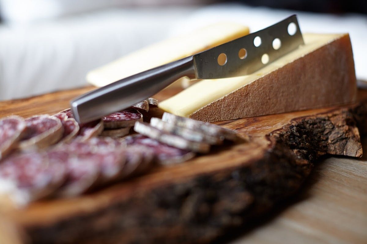a knife sitting on top of a wooden cutting board