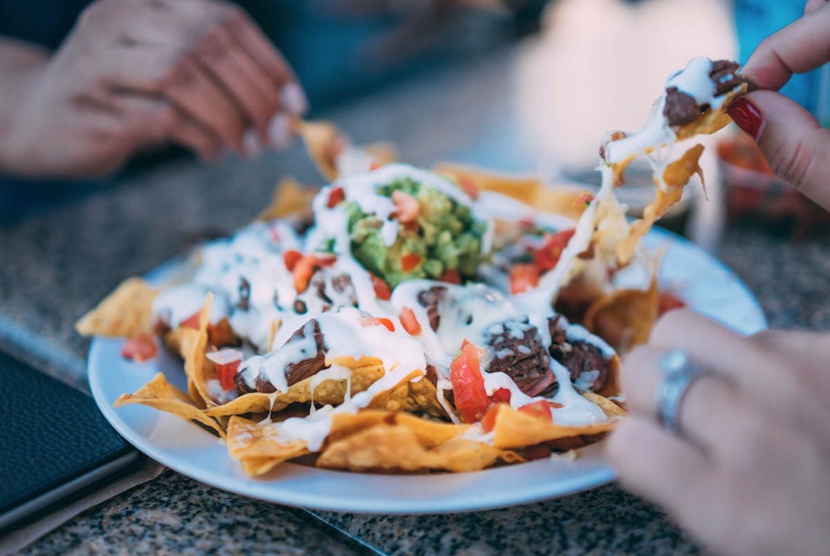 a close up of a person holding a plate of food