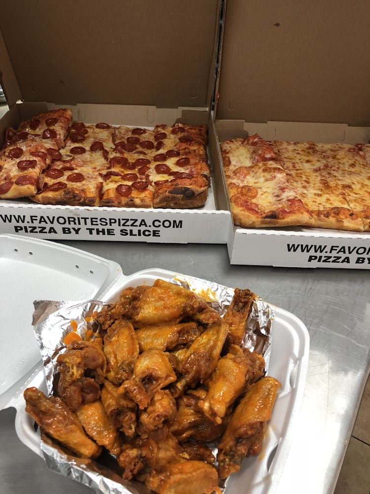 a box filled with different types of pizza sitting on top of a table