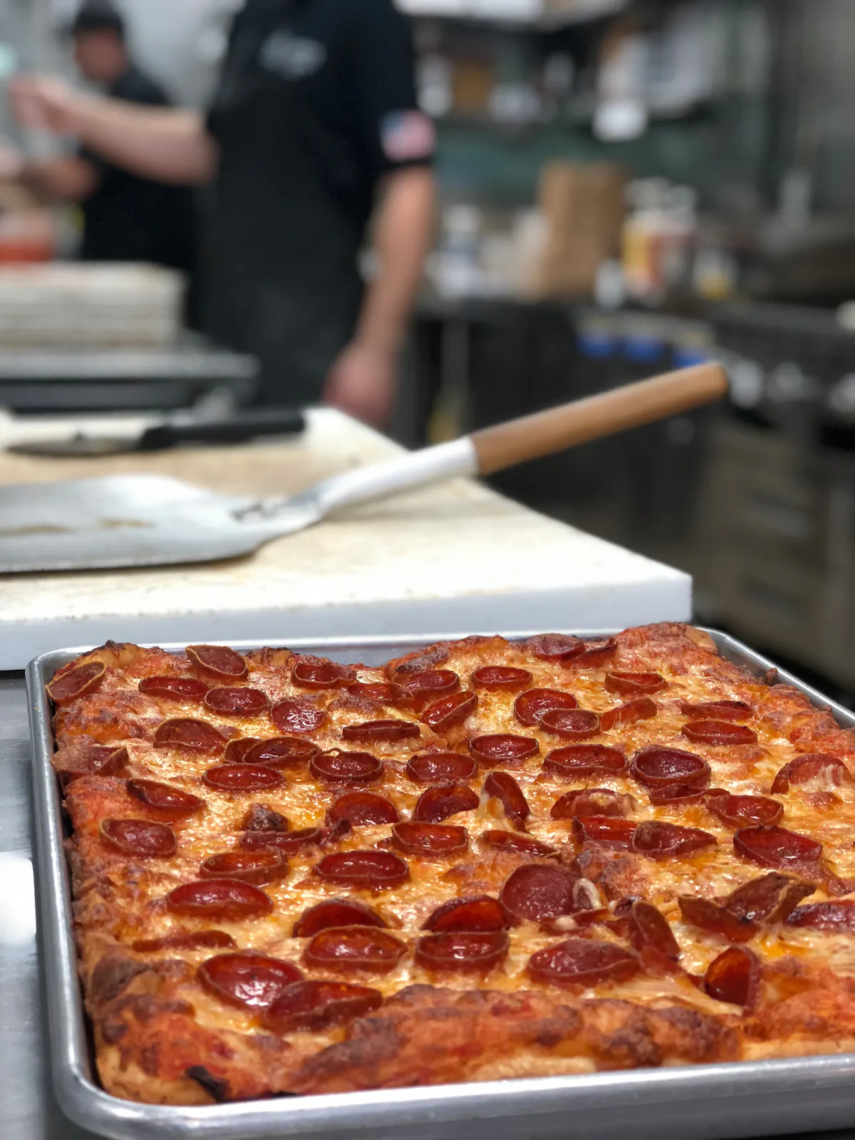 a slice of pepperoni pizza on a tray