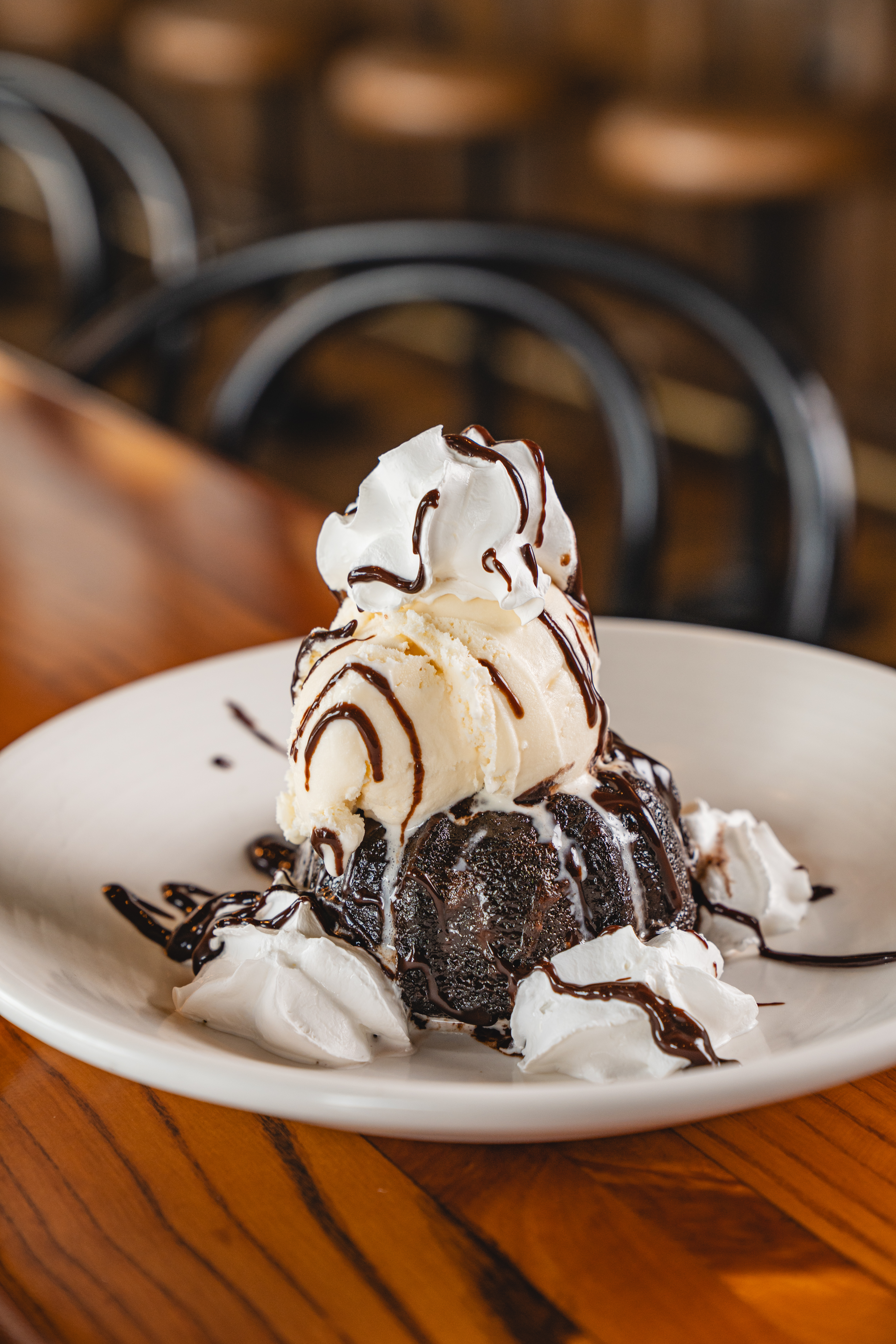 a plate with a piece of cake sitting on top of a wooden table