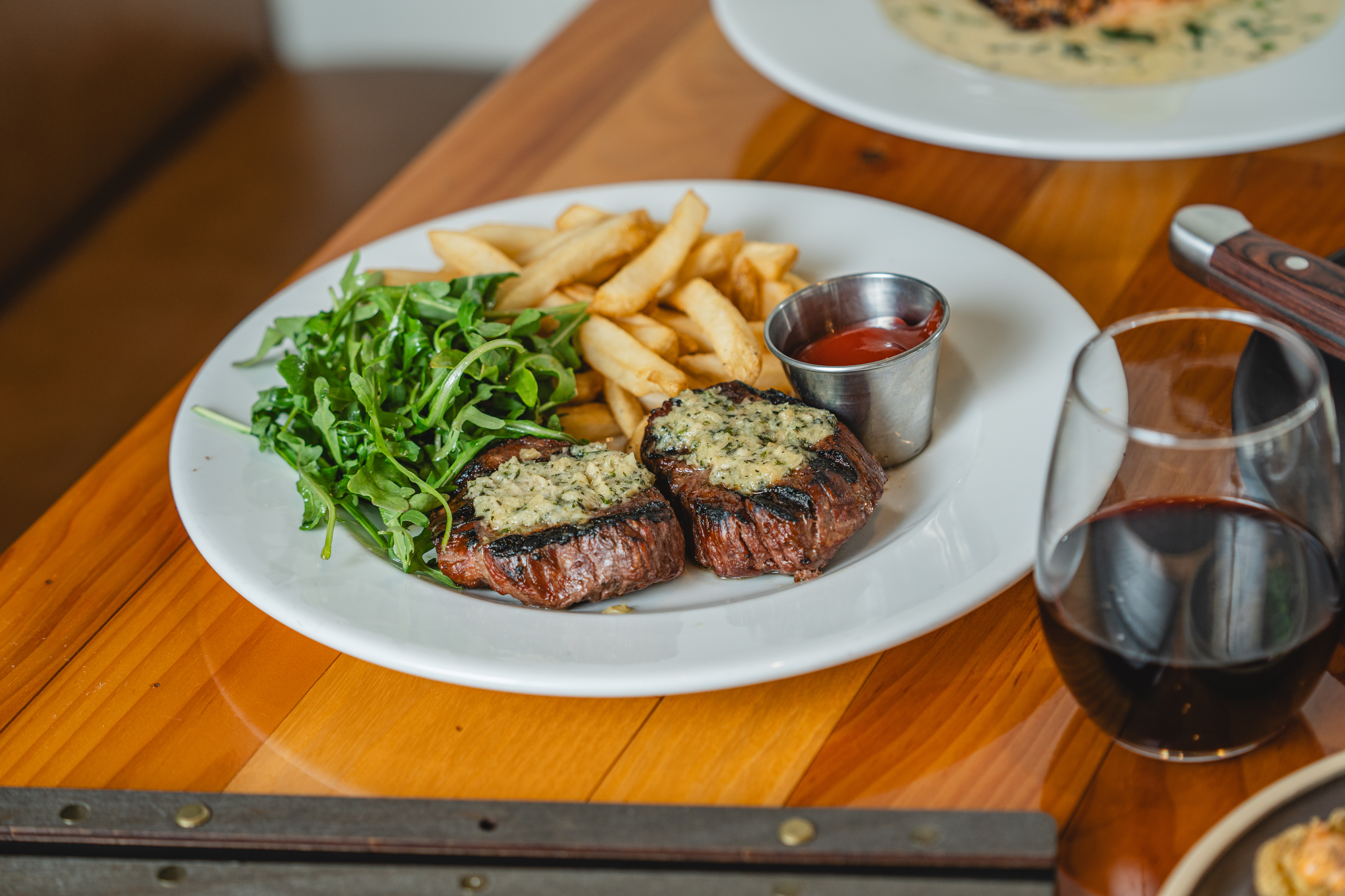 a plate full of food sitting on top of a wooden table