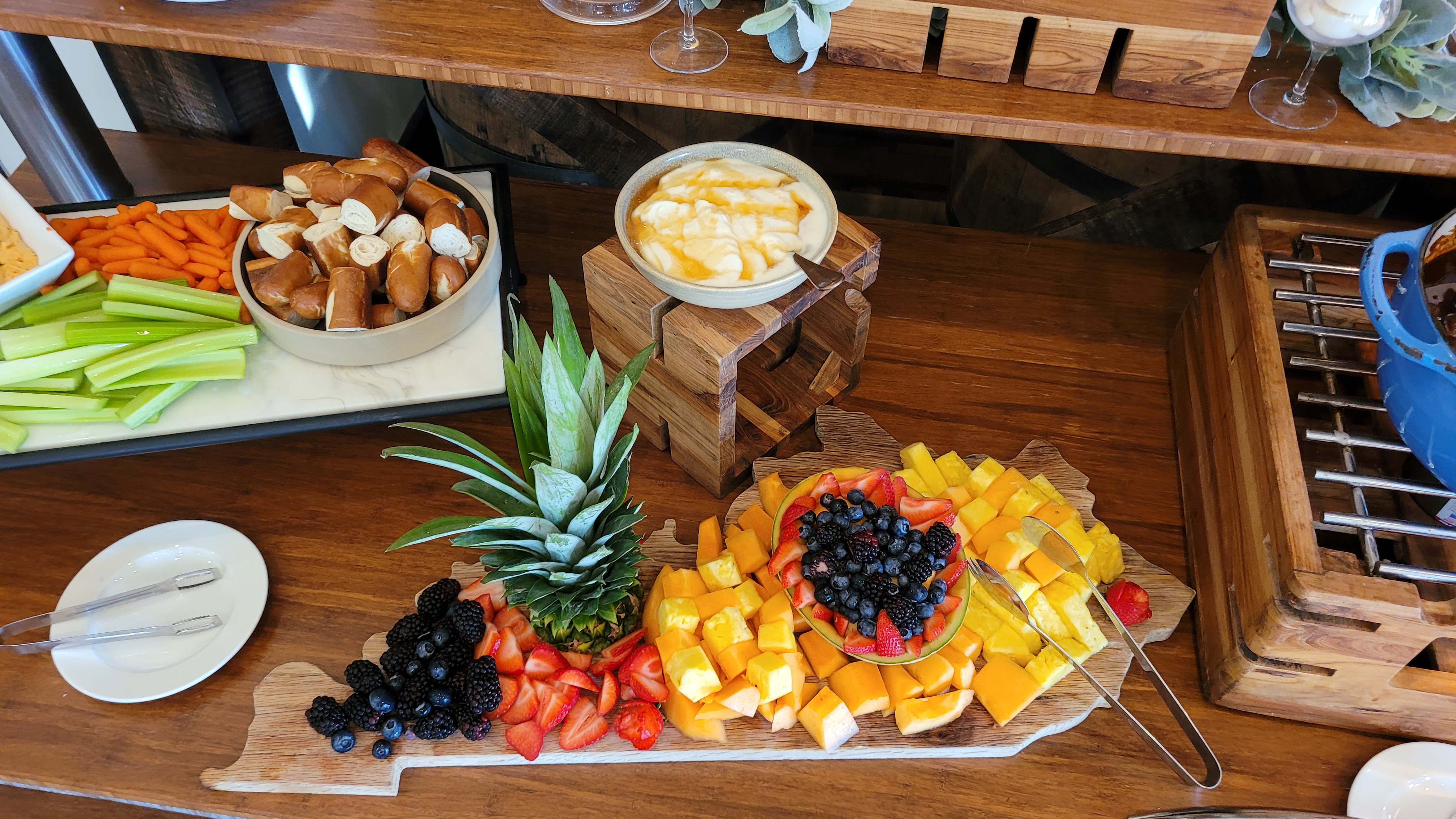 a wooden table topped with plates of food on a plate