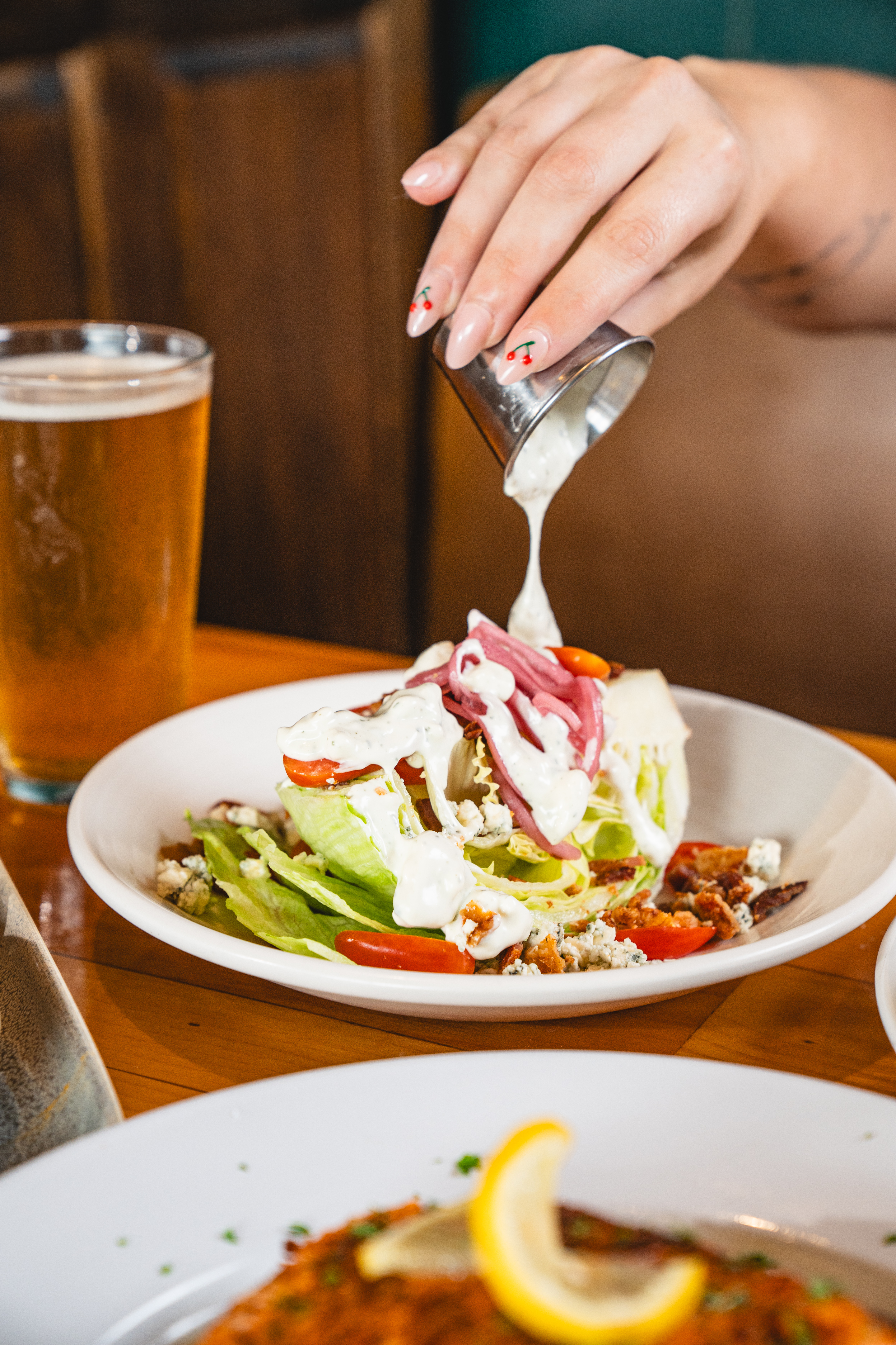 a woman sitting at a table with a plate of food