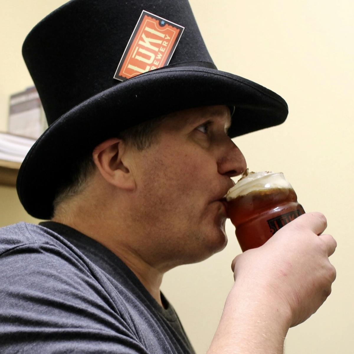 a man drinking from a glass