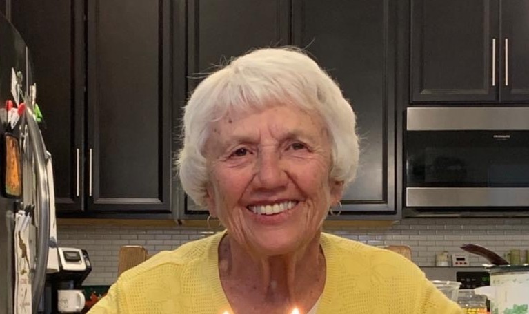 a smiling woman in a kitchen