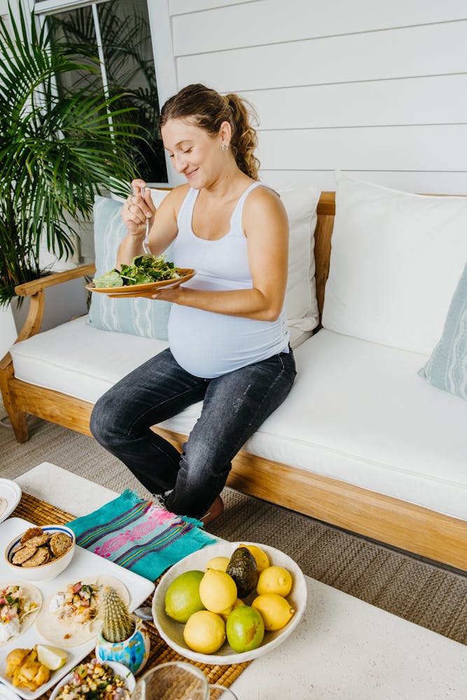 a woman sitting at a table with food