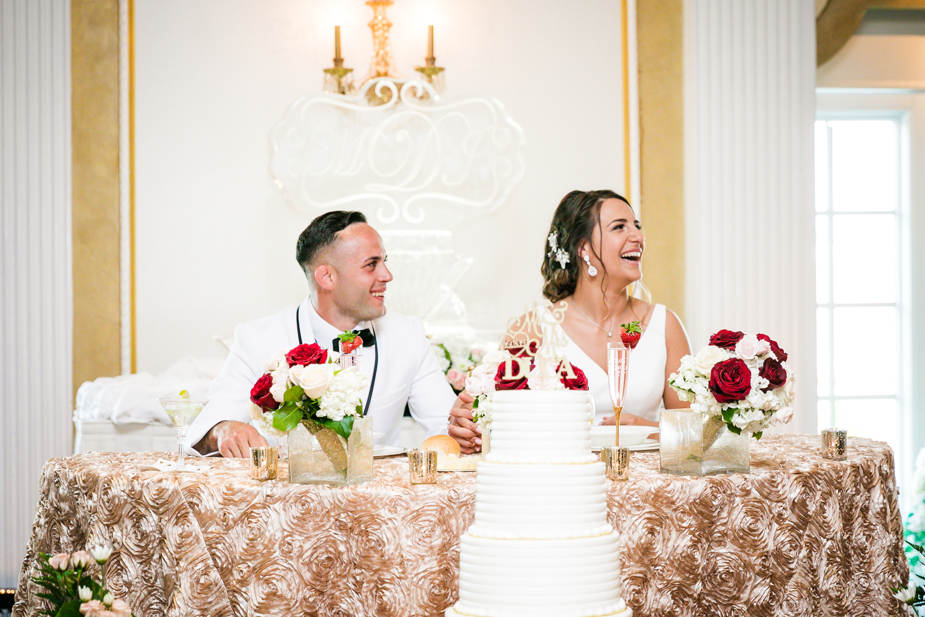 a woman standing in front of a wedding cake