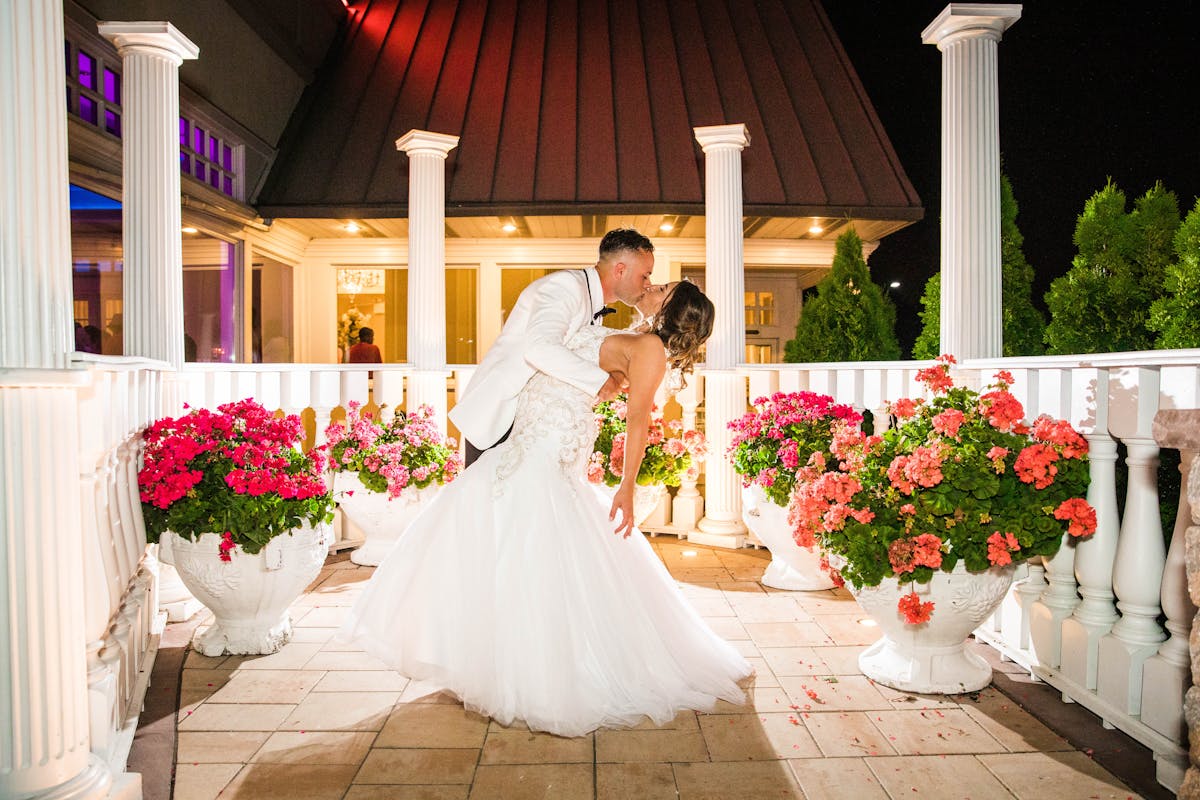 a person standing in front of a wedding cake