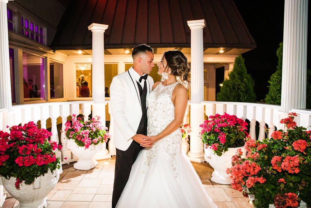 a person standing in front of a wedding cake