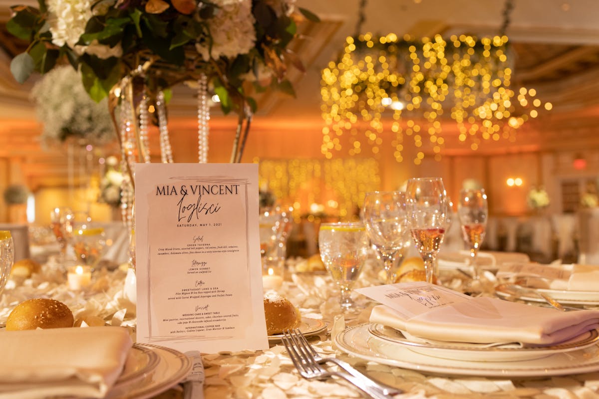 a plate of food and glasses of wine on a table