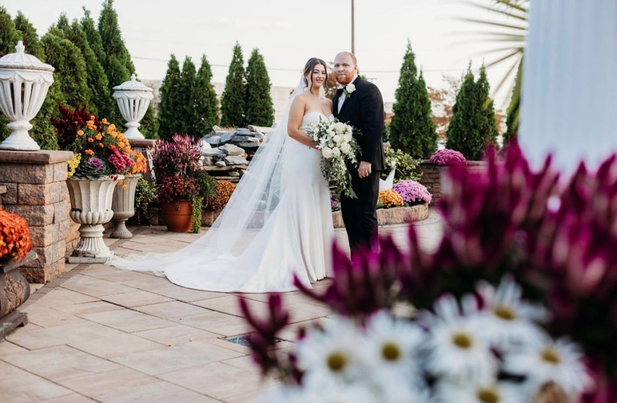 a person standing in front of a flower