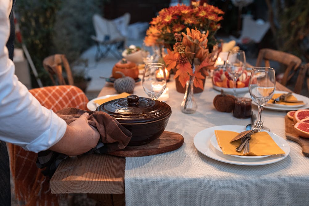 a group of people sitting at a table with a plate of food