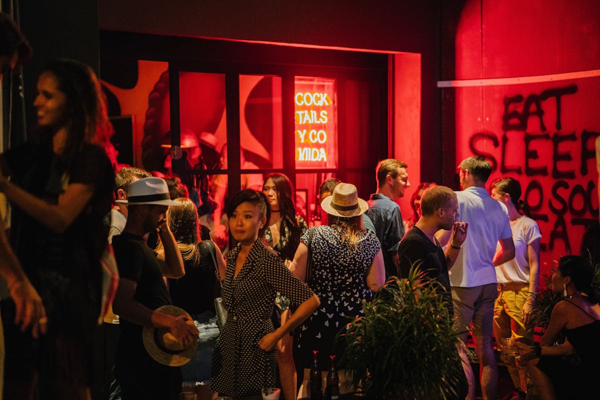 a group of people standing in front of a crowd posing for the camera
